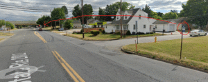 Google Maps streetview picture of Emaus Ave and the corner of 27th St. The bus stop at the intersection is circled in red, along with an arrow pointing to its new location adjacent to I-78
